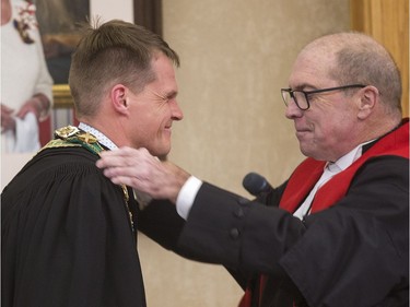 Saskatoon's new mayor Charlie Clark and The Honourable Justice R. Shawn Smith (R) Court of Queen's Bench have a moment after the newly elected mayor was sworn in, October 31, 2016.