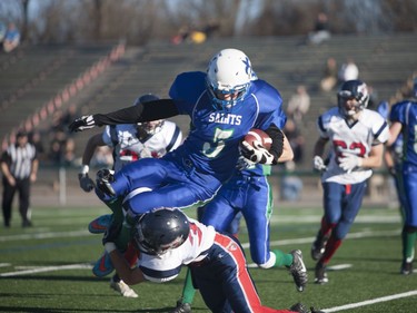 Bishop J. Mahoney Saints #5 David Lett gets tackled during play against the Regina Miller Marauders during the 3A Regional Playoffs at SMF Field in Saskatoon, November 5, 2016.