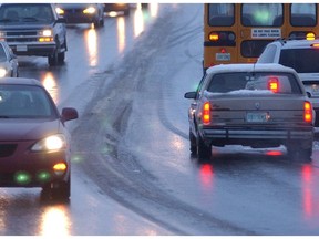 Saskatoon, SK - 030706 - Motorists wind their way slowly down 108th Street Tuesday as roads were covered in ice following a rain. The bus on right was unable to move up the small grade.      Greg Pender/Saskatoon StarPhoenix