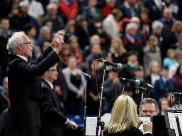 Peter England conducts the orchestra during the annual Remembrance Day Ceremony at SaskTel Centre, the biggest indoor ceremony in Canada, November 11, 2016.