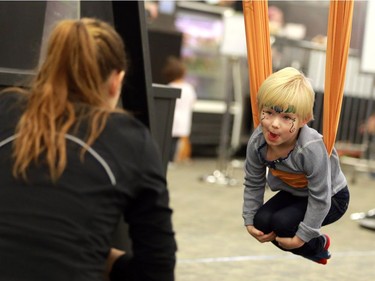 Kelby Davis tries out the Move 'n Soar demo at the family expo at Prairieland Park in Saskatoon on November 20, 2016.