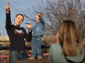 Maksym Bondar points to the sunny sky during a photoshoot with his mom and dad during another record-breaking high temperature day in Saskatoon on November 6, 2016. It reached 19.5 degrees Celsius.