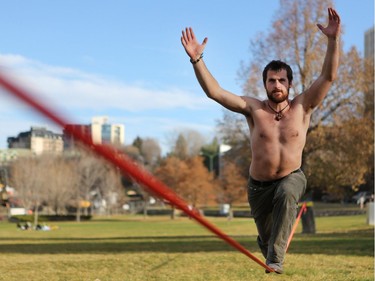 Robert Combs slack lines shirtless at Rotary Park during another record-breaking high temperature day in Saskatoon on November 6, 2016. It reached 18.6 degrees Celsius.