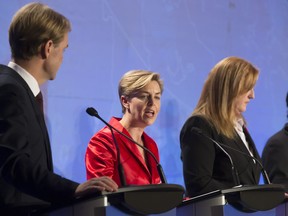 Kellie Leitch, centre, between Chris Alexander and Lisa Raitt, participates in the  Conservative Party's first leadership debate in Saskatoon.