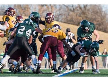 Holy Cross Crusaders tailback Dhugal Baxter-Jones pushing in a touchdown against the  LeBoldus Golden Suns during the High school football 4A provincial final at SMS field in Saskatoon, SK. on Saturday, November 12, 2016. (LIAM RICHARDS/THE STAR PHOENIX)