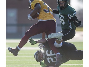 LeBoldus Golden Suns running back Adam Probe breaks a tackle from Holy Cross Crusaders defensive bak Ramsey Derbas during the High school football 4A provincial final at SMS field in Saskatoon, SK. on Saturday, November 12, 2016. (LIAM RICHARDS/THE STAR PHOENIX)