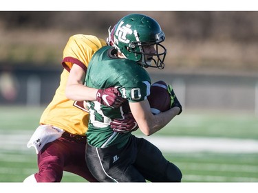 Holy Cross Crusaders receiver Dominie Gursky runs the ball against the LeBoldus Golden Suns during the High school football 4A provincial final at SMS field in Saskatoon, SK. on Saturday, November 12, 2016. (LIAM RICHARDS/THE STAR PHOENIX)