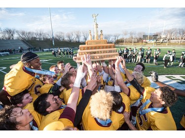 The LeBoldus Golden Suns celebrate their victory over the Holy Cross Crusaders during the High school football 4A provincial final at SMS field in Saskatoon, SK. on Saturday, November 12, 2016. (LIAM RICHARDS/THE STAR PHOENIX)