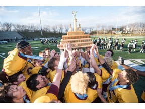 The LeBoldus Golden Suns celebrate their victory over the Holy Cross Crusaders during the High school football 4A provincial final at SMS field in Saskatoon, SK. on Saturday, November 12, 2016. (LIAM RICHARDS/THE STAR PHOENIX)