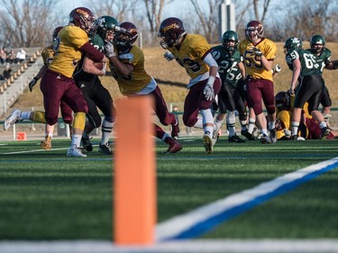 Holy Cross Crusaders receiver Dominie Gursky is stopped outside the goal line by the LeBoldus Golden Suns during the high school football 4A provincial final at SMS field in Saskatoon, November 12, 2016.