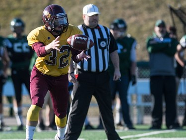 LeBoldus Golden Suns running back Adam Probe grabs a lateral pass against the Holy Cross Crusaders during the high school football 4A provincial final at SMS field in Saskatoon, November 12, 2016.