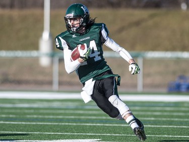 Holy Cross Crusaders quarterback Matthew Wilson runs the ball against the LeBoldus Golden Suns during the high school football 4A provincial final at SMS field in Saskatoon, November 12, 2016.