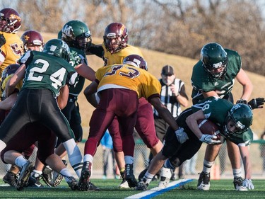 Holy Cross Crusaders tailback Dhugal Baxter-Jones pushing in a touchdown against the LeBoldus Golden Suns during the high school football 4A provincial final at SMS field in Saskatoon, November 12, 2016.
