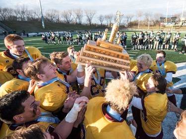 The LeBoldus Golden Suns celebrate their victory over the Holy Cross Crusaders during the high school football 4A provincial final at SMS field in Saskatoon, November 12, 2016.