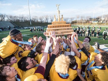 The LeBoldus Golden Suns celebrate their victory over the Holy Cross Crusaders during the high school football 4A provincial final at SMS field in Saskatoon, November 12, 2016.