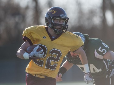 LeBoldus Golden Suns halfback Zachary Moore runs the ball against the Holy Croos Crusaders during the high school football 4A provincial final at SMS field in Saskatoon, November 12, 2016.