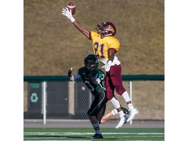 Holy Cross Crusaders receiver Michael Letts grabs a pass that is was tipped by LeBoldus Golden Suns defensive back Mugisha Asharuf during the high school football 4A provincial final at SMS field in Saskatoon, November 12, 2016.