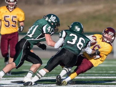 LeBoldus Golden Suns wide receiver Barrett Tippett is tackled by the Holy Cross Crusaders during the high school football 4A provincial final at SMS field in Saskatoon, November 12, 2016.