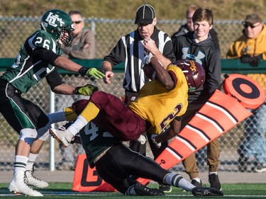 LeBoldus Golden Suns running back Semba Mbasela is knocked out of bounds by the Holy Cross Crusaders during the high school football 4A provincial final at SMS field in Saskatoon, November 12, 2016.