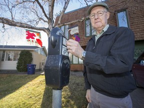 Gordon Millham stands with the old City of Saskatoon parking meter which is installed at the end of his driveway.
