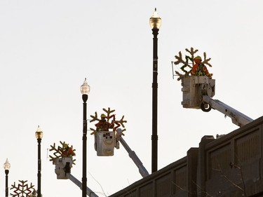 City workers hang Christmas decorations on the Broadway Bridge, November 15, 2016.