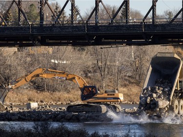 Work continues on a berm under the remaining span of the old Traffic Bridge, slated for deconstruction in the near future, as work progresses, November 15, 2016.