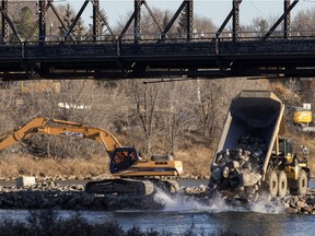 Work continues on a berm under the remaining span of the old Traffic Bridge, slated for deconstruction in near future, as work progresses, Tuesday, November 15, 2016.