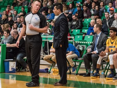 University of Brandon Bobcats head coach Gil Cheung speaks with an official as his team takes on the University of Saskatchewan Huskies in CIS Men's Basketball action at the PAC in Saskatoon, November 19, 2016.