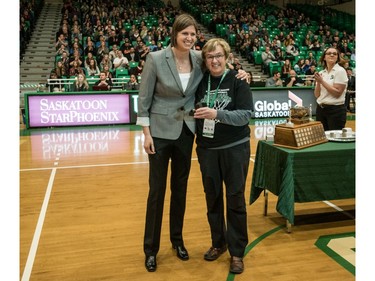 University of Saskatchewan Huskies head coach Lisa Thomaidis is present with last year's championship ring by U of S Chancellor Vera Pezer following a game against the University of Brandon Bobcats in CIS Women's Basketball action at the PAC in Saskatoon, November 19, 2016.