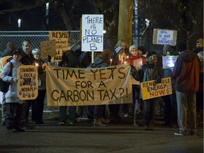 People attend a Stop Kinder Morgan Solidarity Vigil at the gates to Prairieland Park hosted by Climate Justice Saskatoon on Monday. The vigil aims to gather people opposed to not just the Kinder Morgan pipeline, but Keystone XL, Energy East and DAPL pipelines. The organizers chose Prairieland Park, since it's the venue for the Premier's holiday party. Monday was also a national day of action against the Kinder Morgan pipeline. (GREG PENDER/STAR PHOENIX)