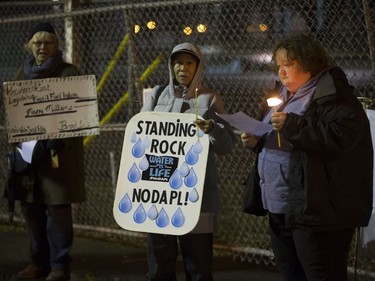 People attend a Stop Kinder Morgan Solidarity Vigil at the gates to Prairieland Park, hosted by Climate Justice Saskatoon, November 21, 2016.