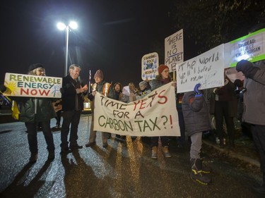 People attend a Stop Kinder Morgan Solidarity Vigil at the gates to Prairieland Park, hosted by Climate Justice Saskatoon, November 21, 2016.