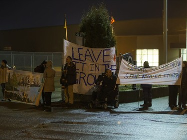 People attend a Stop Kinder Morgan Solidarity Vigil at the gates to Prairieland Park, hosted by Climate Justice Saskatoon, November 21, 2016.