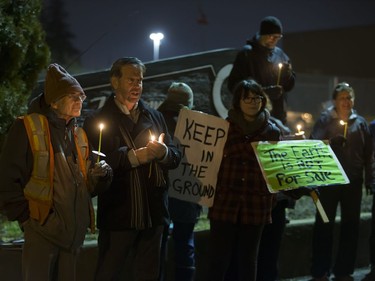 People attend a Stop Kinder Morgan Solidarity Vigil at the gates to Prairieland Park, hosted by Climate Justice Saskatoon, November 21, 2016.