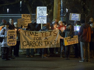 People attend a Stop Kinder Morgan Solidarity Vigil at the gates to Prairieland Park, hosted by Climate Justice Saskatoon, November 21, 2016.