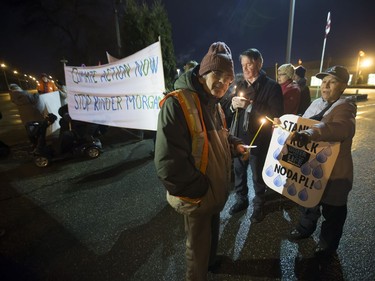 People attend a Stop Kinder Morgan Solidarity Vigil at the gates to Prairieland Park, hosted by Climate Justice Saskatoon, November 21, 2016.