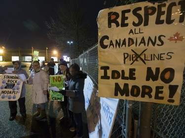 People attend a Stop Kinder Morgan Solidarity Vigil at the gates to Prairieland Park, hosted by Climate Justice Saskatoon, November 21, 2016.