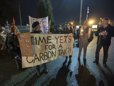 People attend a Stop Kinder Morgan Solidarity Vigil at the gates to Prairieland Park, hosted by Climate Justice Saskatoon, November 21, 2016.