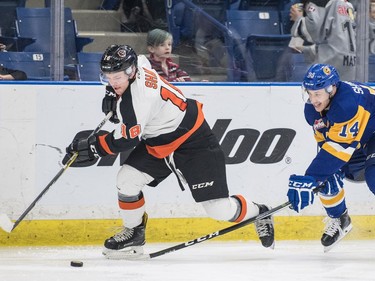 Medicine Hat Tigers centre Mason Shaw battles for the puck with Saskatoon Blades centre Jesse Shynkaruk in second period WHL action in Saskatoon, November 26, 2016.