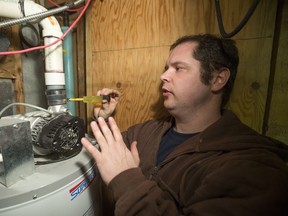 Plumber Aaron Carter goes to work on a problem hot water heater in a west side home, Tuesday, October 25, 2016.  (GREG PENDER/STAR PHOENIX)