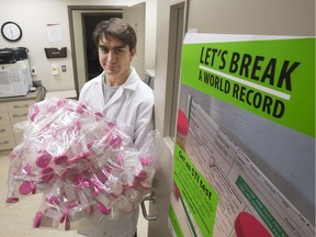 University of Saskatchewan student organizer Kyle Moroziuk holds some of the more than 800 test containers at the student health centre on campus used to attempt to set a record for STI testing numbers in Saskatoon, Monday, October 31, 2016.