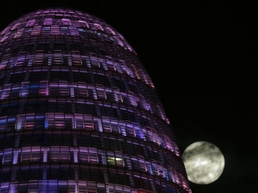 The moon rises behind the Agbar tower in Barcelona, Spain, November 14, 2016. The brightest moon in almost 69 years, a phenomenon known as the supermoon, is lighting up the sky in a treat for star watchers around the globe.