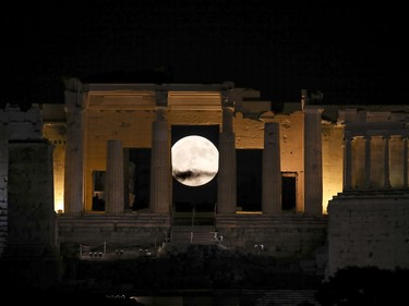 The moon rises behind the Propylaia at the Acropolis hill in Athens, Greece, November 14, 2016. The brightest moon in almost 69 years will be lighting up the sky this week in a treat for star watchers around the globe.