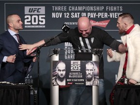 UFC president Dana White, center, stands between fighters Eddie Alvarez, left, and Conor McGregor during a news conference ahead of the UFC 205 mixed martial arts fights, Thursday, Nov. 10, 2016, at Madison Square Garden in New York. McGregor and Alvarez will fight each other on Saturday.