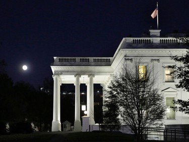 The moon rises over the White House in Washington on November 13, 2016.