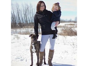 Cindy Davis is pictured with her daughter and their dog, a pitbull/mastiff, Aspen. Aspen was declared dangerous on Dec. 1. (Photo courtesy Kayla Norlin Photography)
