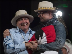 Assembly of First Nations Chief Perry Bellegarde (left) is embraced by Tragically Hip frontman Gord Downie after he was presented with a hat during a ceremony honouring Downie at the AFN Special Chiefs assembly in Gatineau, Que., Tuesday, December 6, 2016.