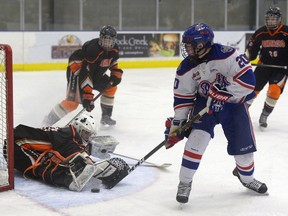 Regina Pat Canadians forward Jordan Kazymyra, 20, is stopped by Saskatoon Contacts goalie Jordan Fey, 30, during a game held at Co-operators Centre in Regina, Sask. on Sunday Dec. 4, 2016. MICHAEL BELL