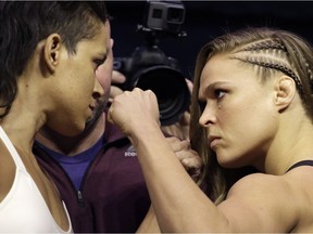 Ronda Rousey, right, and Amanda Nunes face off for photographers during an event for UFC 207, Thursday, Dec. 29, 2016, in Las Vegas. Rousey is scheduled to fight Nunes in a mixed martial arts women's bantamweight championship bout Saturday in Las Vegas.