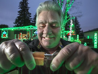 Scott Lambie plugs in his unbelievable christmas lights display choreographed to music on Clinkskill Drive, December 1, 2016. Thousands come to see his display every year.